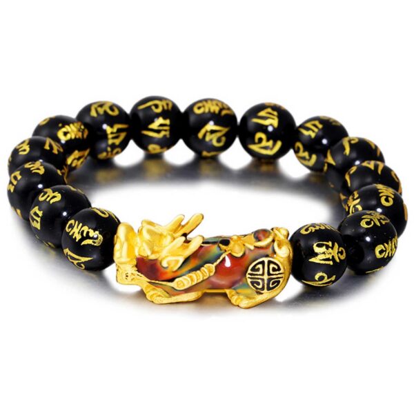 A striking bracelet featuring glossy black obsidian beads inscribed with golden Tibetan mantras, centered by an ornate gold and blue enamel Pixiu charm.