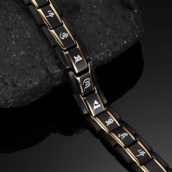 A robust black titanium link bracelet featuring gold inlays, red germanium dots, and sacred Tibetan mantra engravings.
