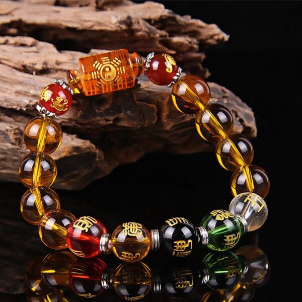 This vibrant bracelet features dominant golden-yellow citrine beads accented by red, green, black, and clear crystals representing the five elements, centered around an engraved wealth cylinder.