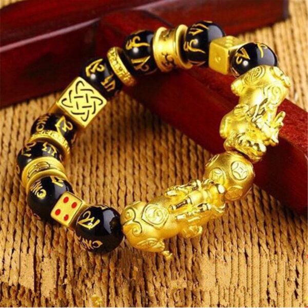 Features bold gold-plated double Pixiu charms and geometric spacers alternating with glossy black obsidian beads engraved with mantras.
