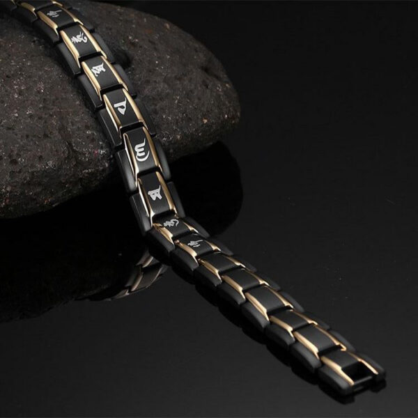 A robust black titanium link bracelet featuring gold inlays, red germanium dots, and sacred Tibetan mantra engravings.