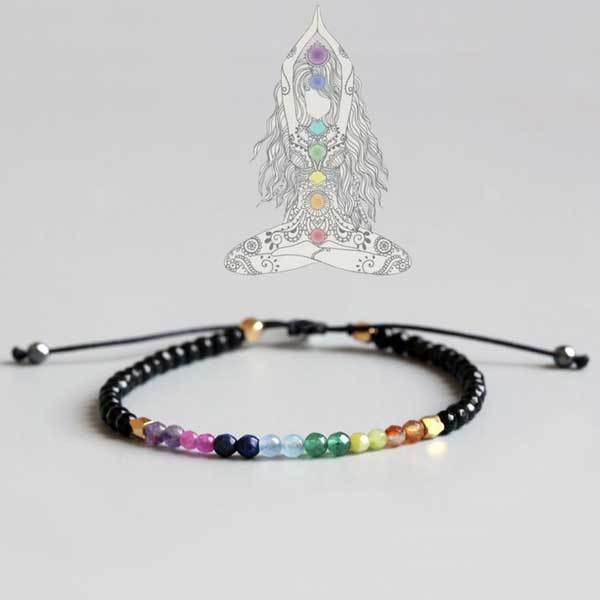 Two adjustable beaded bracelets featuring a spectrum of colorful chakra stones and mixed earth-toned gemstones set against black cords with gold accents.