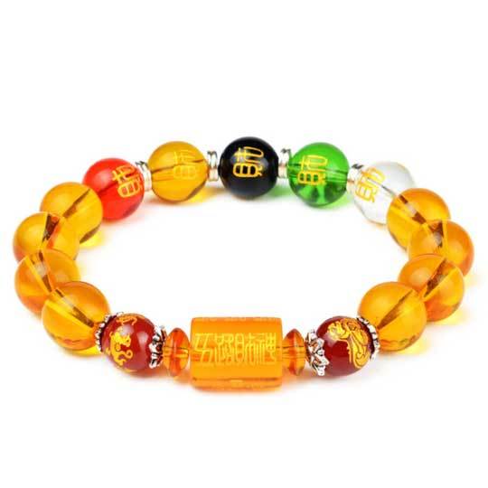 This vibrant bracelet features dominant golden-yellow citrine beads accented by red, green, black, and clear crystals representing the five elements, centered around an engraved wealth cylinder.
