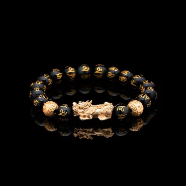 Glossy black obsidian beads engraved with golden mantras are centered by a detailed gold Pixiu beast and coin charms.