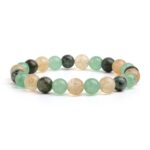 This beaded bracelet showcases an alternating pattern of polished golden citrine, light green aventurine, and speckled dark green turquoise stones.