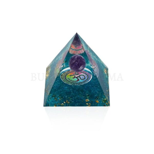 A translucent teal resin pyramid embedded with gold flakes and a central purple amethyst sphere marked with an Om symbol.