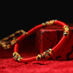 A woven adjustable string bracelet featuring interlaced threads of red, green, yellow, white, and black representing the sacred Panchavarna.