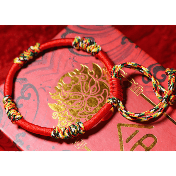A woven adjustable string bracelet featuring interlaced threads of red, green, yellow, white, and black representing the sacred Panchavarna.