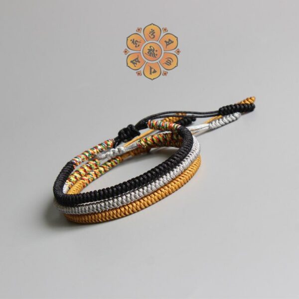 Four intricately braided cord bracelets in black, white, gold, and multi-colors featuring adjustable sliding knots.