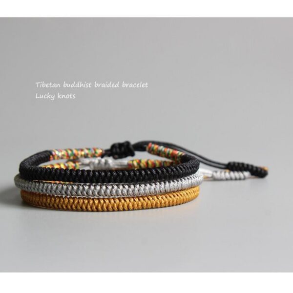 Four intricately braided cord bracelets in black, white, gold, and multi-colors featuring adjustable sliding knots.